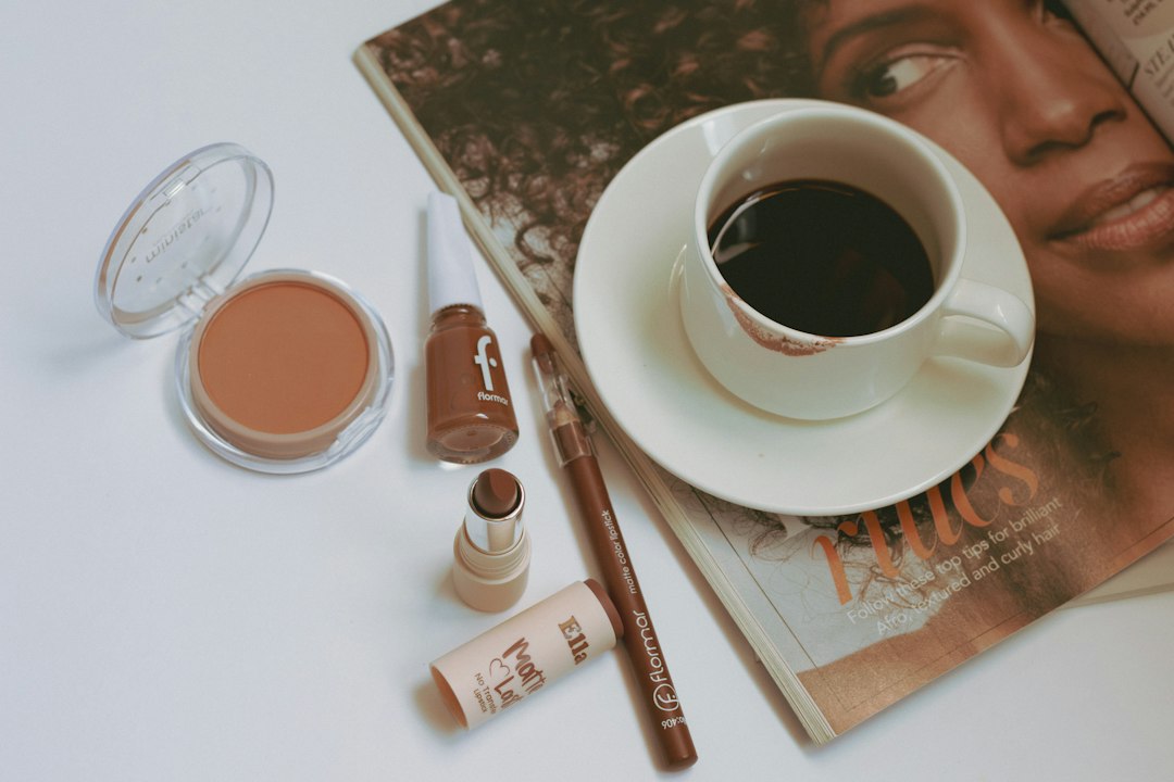 Flat lay of coffee and various brown-toned makeup products